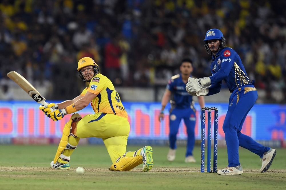 (FILES) In this file photo taken on May 12, 2019 Chennai Super Kings cricketer Shane Watson (L) plays a shot -- with blood staining his uniform behind his pads on his left knee -- during the 2019 Indian Premier League (IPL) Twenty20 final cricket match be