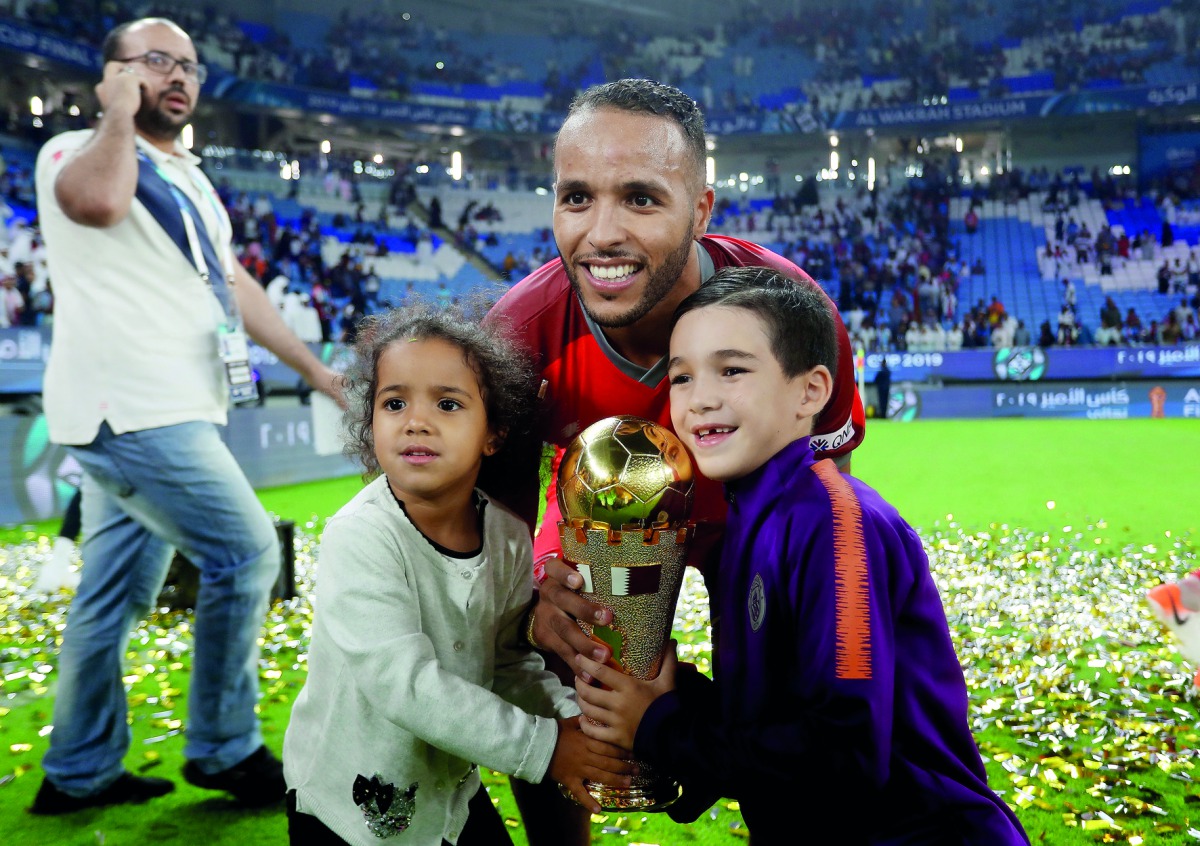 Al Duhail’s Youssef El Arabi celebrates with the trophy. 
