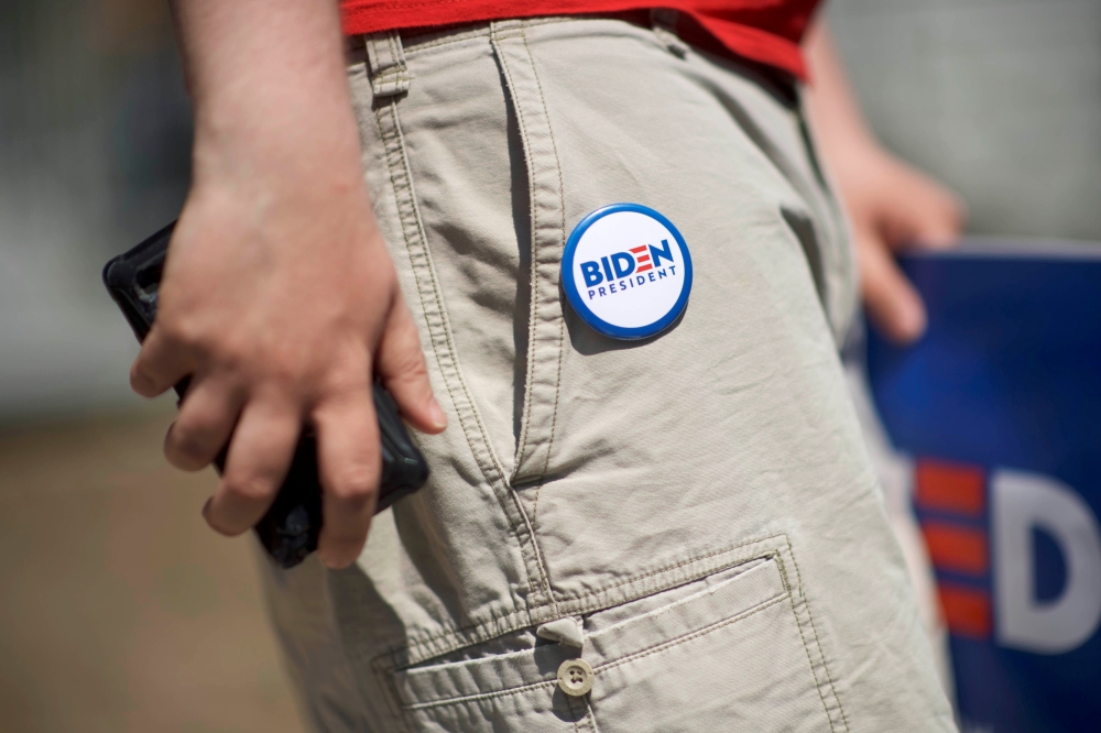 A supporter wears a pin on his shorts reading 