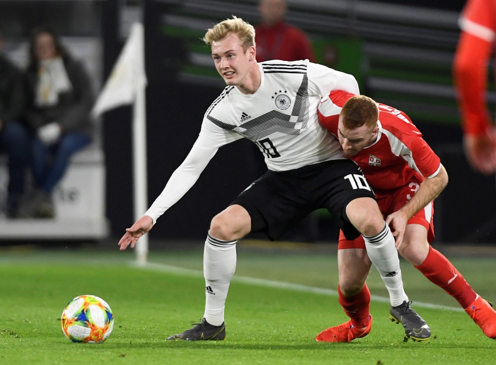 :FILE PHOTO: Germany's Julian Brandt in action with Serbia's Miroslav Bogosavac REUTERS/Fabian Bimmer/File Photo