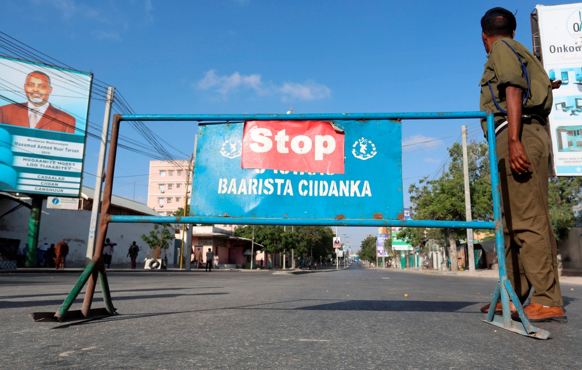 A Somali policeman stands guard along a road which was blocked to control motor vehicle traffic during a security lock down in capital Mogadishu, February 7, 2017. Reuters/Feisal Omar