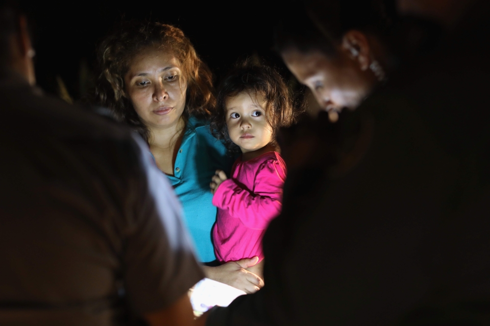 Central American asylum seekers including a Honduran girl and her mother near the US-Mexico border in McAllen, Texas on June 12, 2018. AFP/Getty Images North America/John Moore