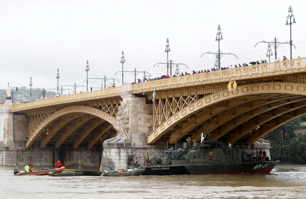 A Hungarian army boat passes under Margaret Bridge after a ship accident that killed several people on the Danube river in Budapest, Hungary, May 30, 2019. REUTERS/Bernadett Szabo