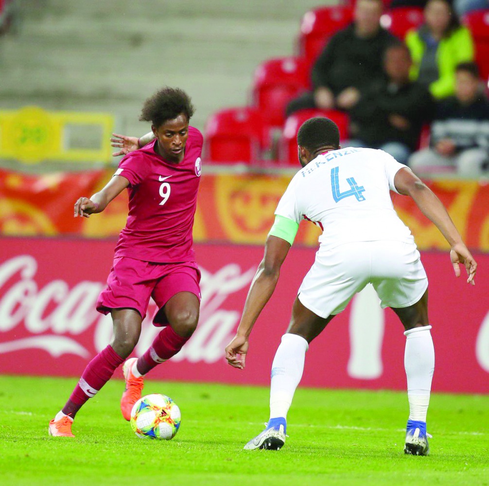 Qatari forward Yusuf Abdurisag (left) vies for the ball possession against United States defender Mark Mckenzie during their final Group D match of the FIFA U-20 World Cup, played in Tychy, Poland, yesterday.
