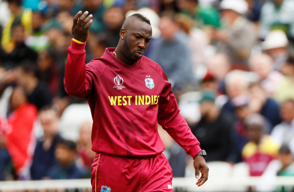 West Indies' Andre Russell signals for treatment. Reuters/Jason Cairnduff