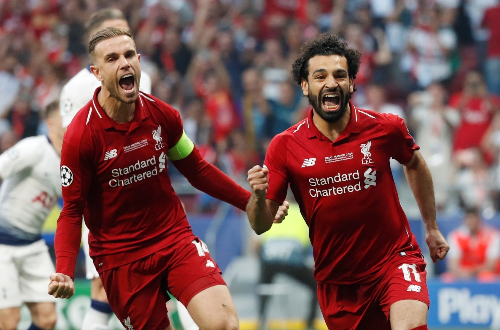Liverpool's Mohamed Salah celebrates scoring their first goal from the penalty spot with Jordan Henderson REUTERS/Susana Vera