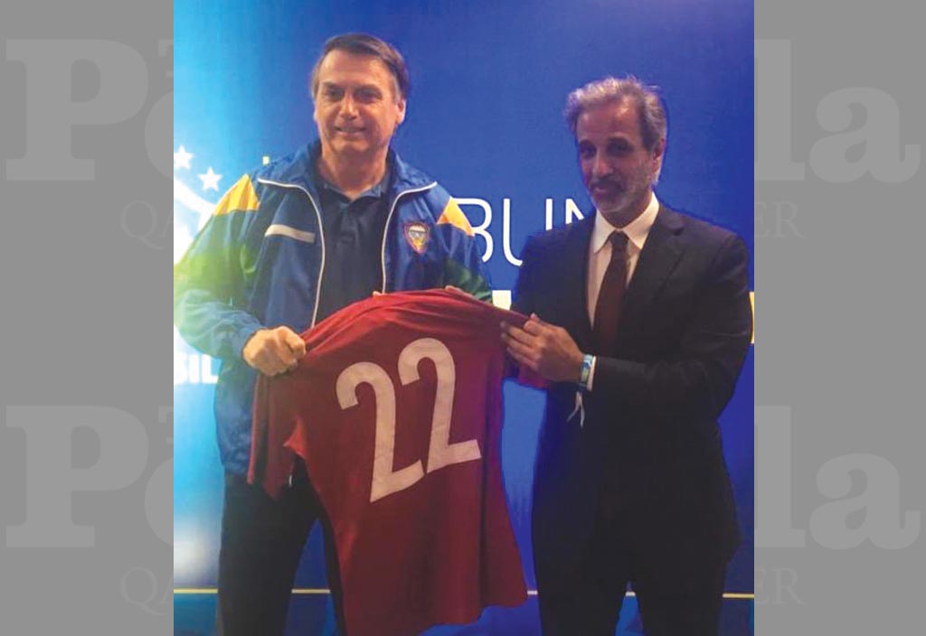 Sheikh Hamad bin Khalifa bin Ahmed Al Thani, President of the Qatar Football Association (QFA) presents a Qatari team jersey to Brazilian President Jair Bolsonaro ahead of the international friendly in Brasilia, on Wednesday.