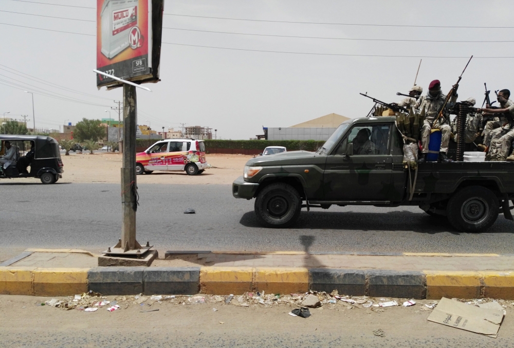 Sudanese security forces drive through the main road linking Omdurman with its twin city Khartoum on the first day of a civil disobedience campaign across Sudan on June 9, 2019.  AFP 