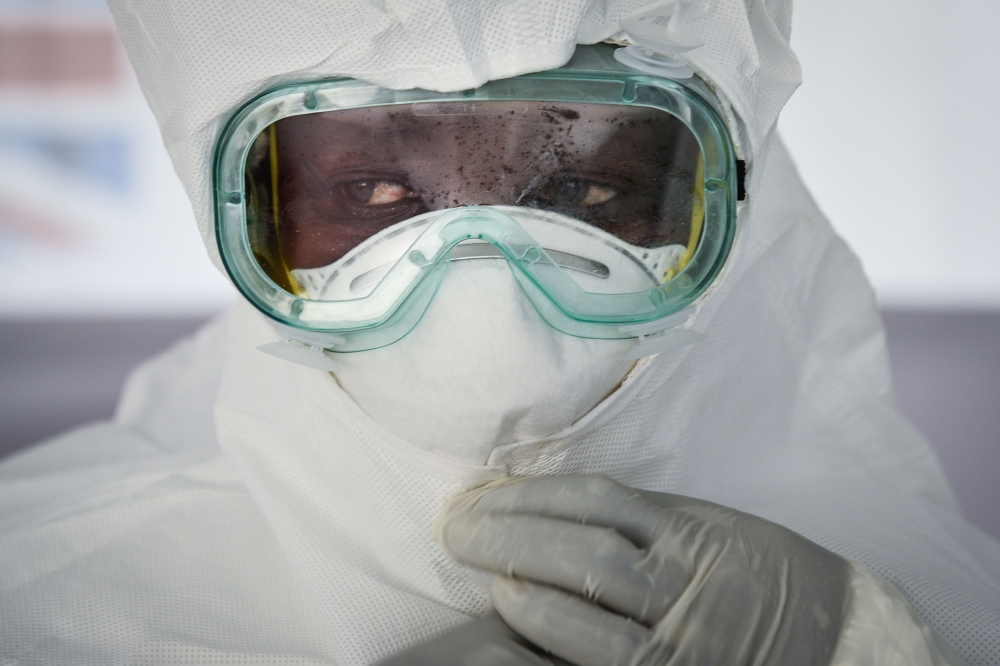 FILE PHOTO: A member of the medical staff of the Ebola Treatment Unit (ETU) puts on her Personal Protective Equipment (PPE) during a weekly rehearsal at the Bwera General Hospital in Bwera bordering with DRC, western Uganda. AFP / Isaac Kasamani