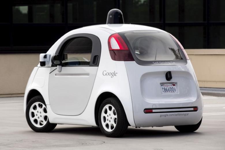FILE PHOTO:  Journalists take a test drive in a prototype of Google owned self-driving vehicle during a media preview in Mountain View, California, September 29, 2015. Reuters/Elijah Nouvelage