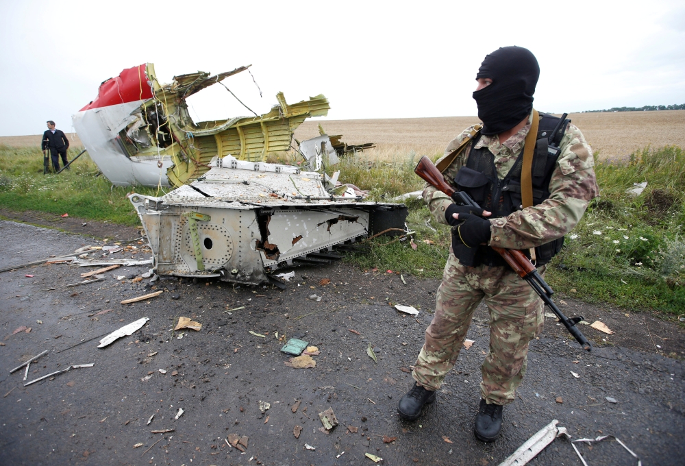 FILE PHOTO: A pro-Russian separatist stands at the crash site of Malaysia Airlines flight MH17, near the village of Hrabove (Grabovo) in Donetsk region, Ukraine, July 18, 2014. REUTERS/Maxim Zmeyev/File Photo