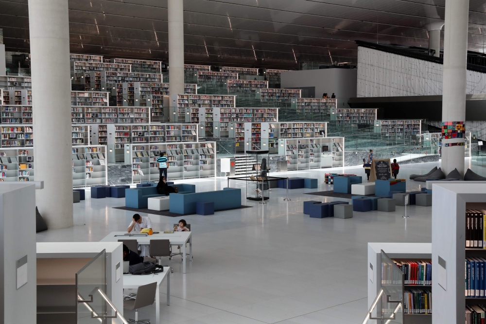 People use the reading area of the Qatar National Library in the capital Doha on May 19, 2019. / AFP / KARIM JAAFAR 