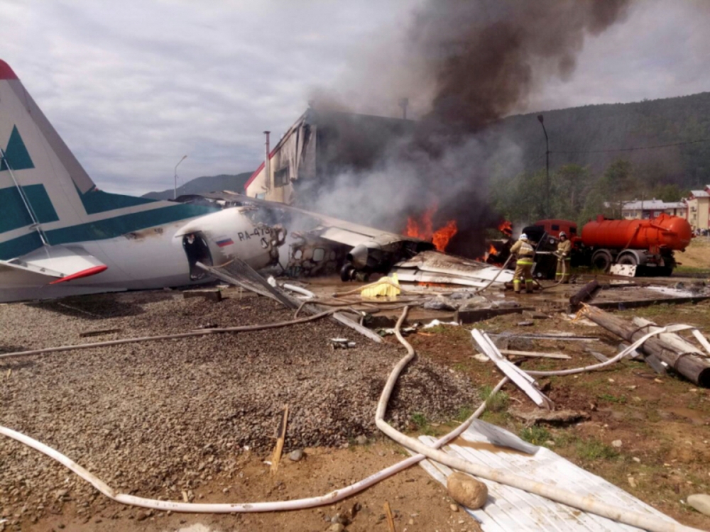 An Antonov An-24 passenger plane is seen on fire after an emergency landing in the town of Nizhneangarsk, Russia June 27, 2019. Russian Emergencies Ministry/Handout via REUTERS 