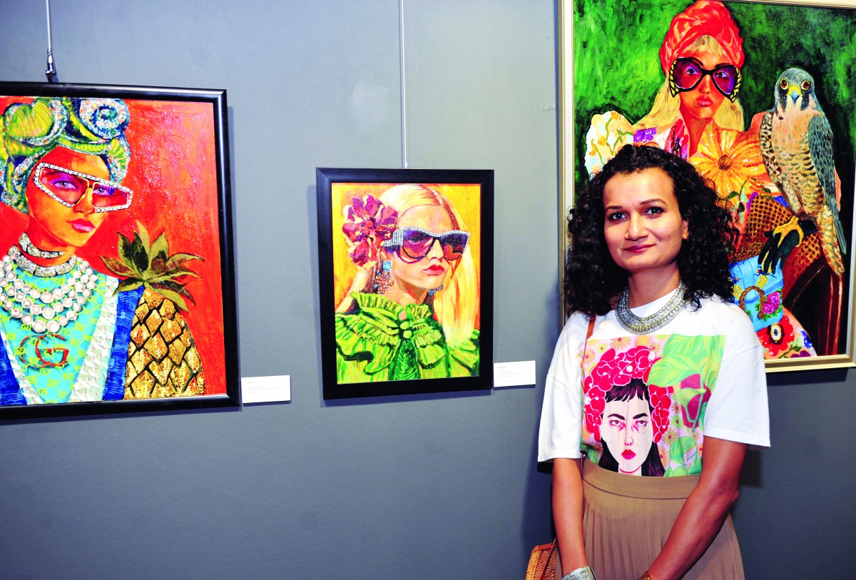 Indian Artist Surabhi Gaikwad with some of her paintings at the opening of “Portraits” exhibition at Katara Building 19. Pic: Abdul Basit/The Peninsula