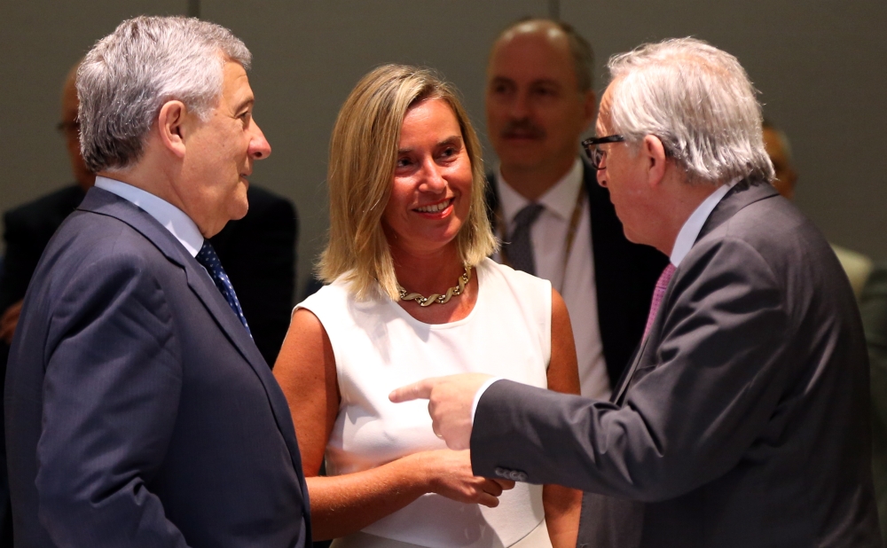 President of the European Commission Jean-Claude Juncker (R) speaks with President of European Parliament Antonio Tajani (L) and European Union High Representative for Foreign Affairs and Security Policy Federica Mogherini (C) during extraordinary summit 