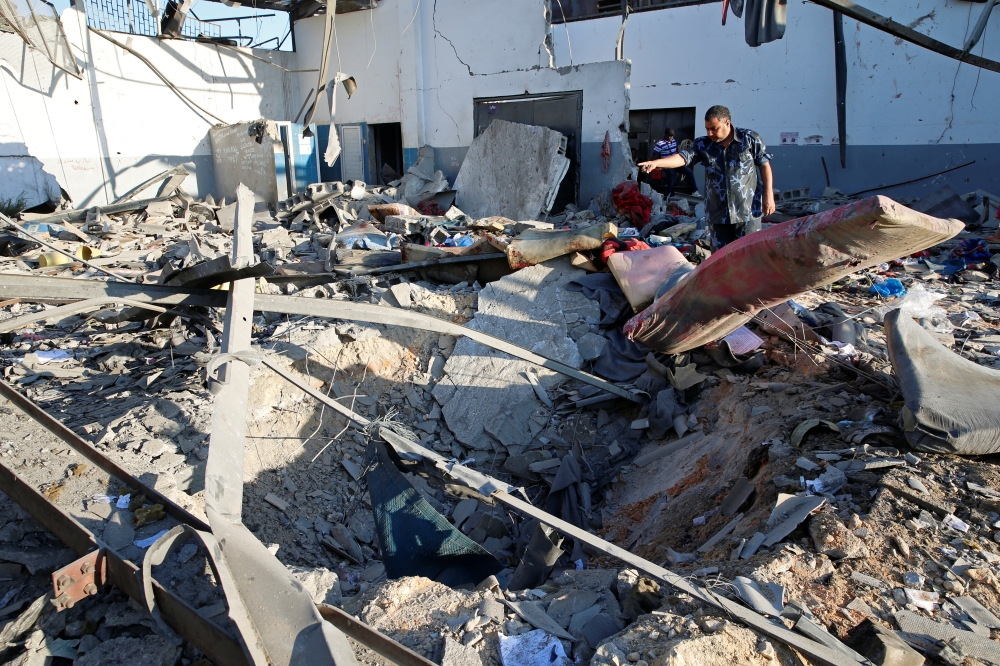 A policeman is seen at a detention centre for mainly African migrants that was hit by an airstrike in the Tajoura suburb of the Libyan capital of Tripoli, Libya July 3, 2019. REUTERS/Ismail Zitouny