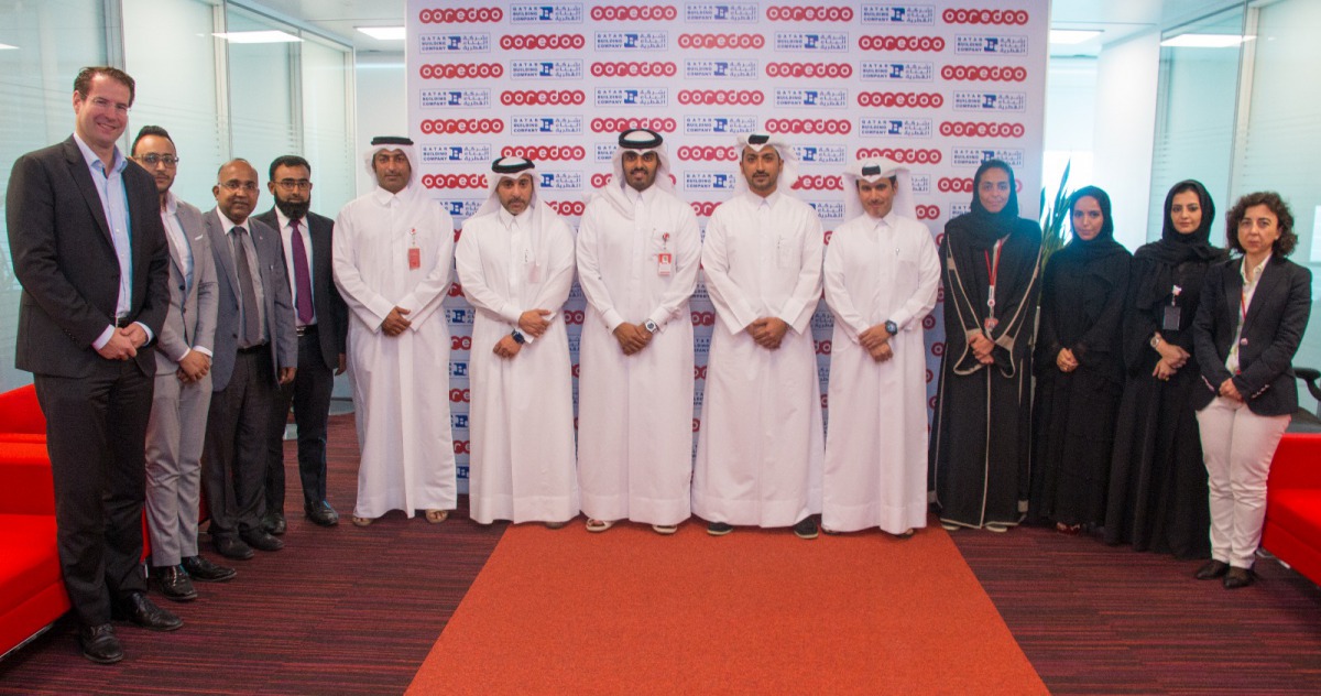 Sheikh Nasser bin Hamad bin Nasser Al Thani, Chief Business Officer, Ooredoo Qatar; and Bader Mustafawi, Group Commercial Manager, Qatar Building Company; with other officials during the agreement signing ceremony.