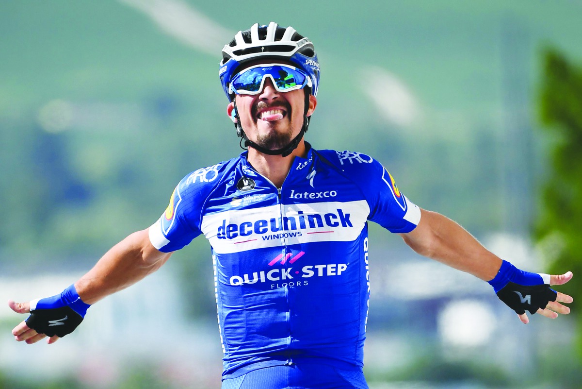 French rider Julian Alaphilippe celebrates his victory as he crosses the finish line of the third stage of the 106th edition of the Tour de France cycling race between Binche and Epernay, in Epernay on July 8, 2019. AFP/Anne-Christine Poujoulat