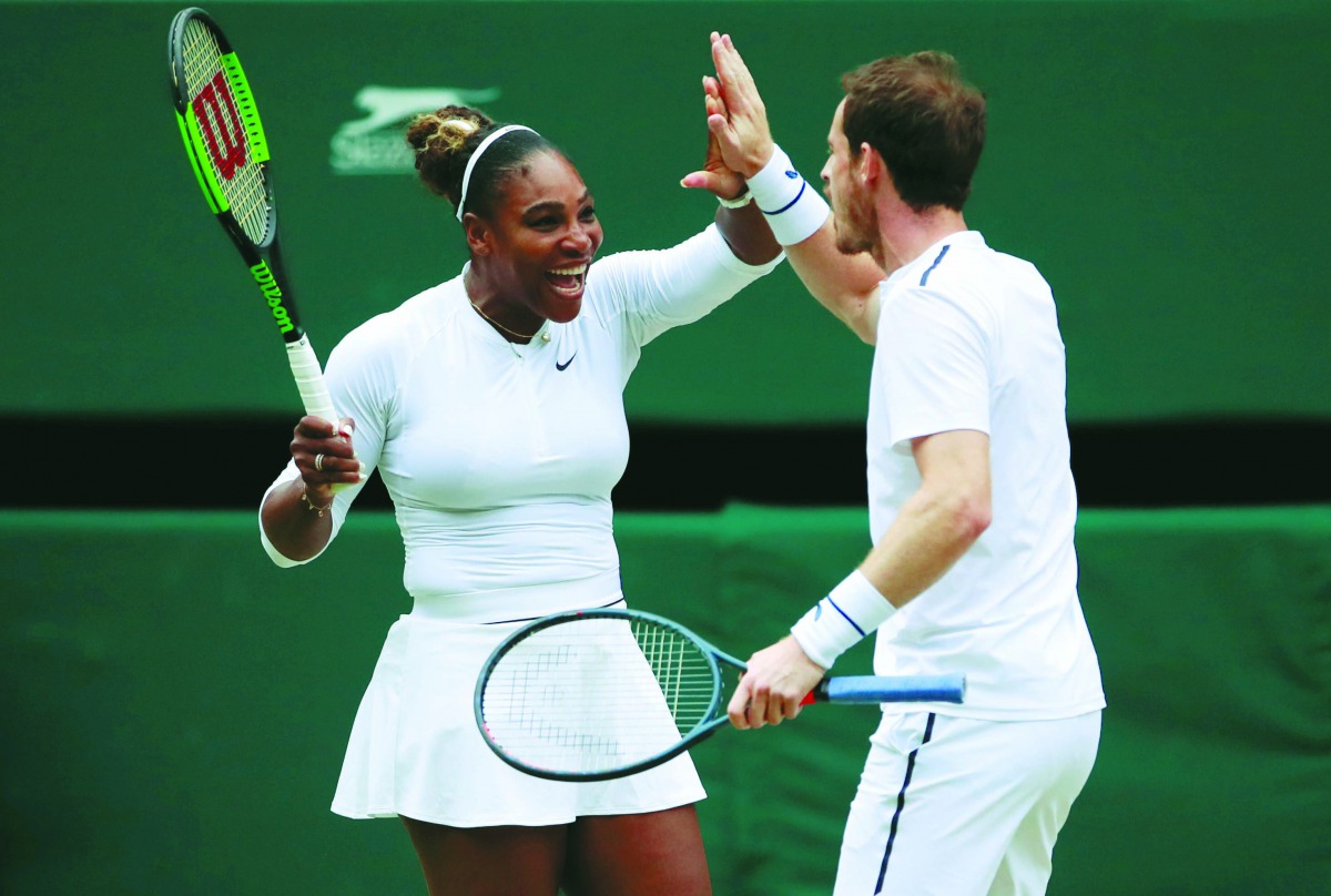 Serena Williams of the U.S. and Britain's Andy Murray react during their second round mixed doubles match against France's Fabrice Martin and Raquel Atawo of the U.S. Reuters/Andrew Couldridge