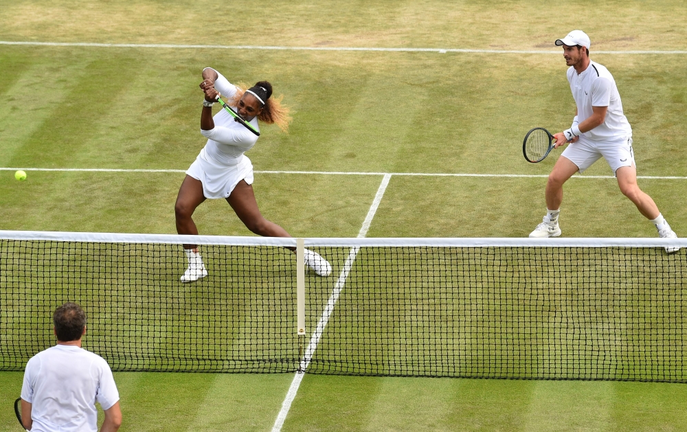 Britain's Andy Murray (R) and US player Serena Williams return against Brazil's Bruno Soares and US players Nicole Melichar during their mixed doubles third round match on day nine of the 2019 Wimbledon Championships at The All England Lawn Tennis Club in