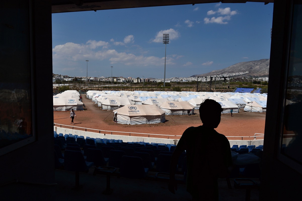 Representative image: A refugee boy walks in front of UNHCR tents set in the former Helliniko Olympic complex for mainly Afghani refugees on May 10, 2016 in Athens’ southern suburb. AFP/Louisa Gouliamaki
