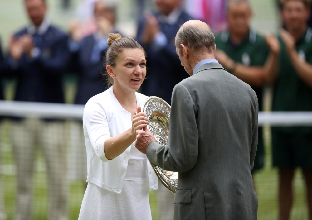 Romania's Simona Halep is presented the trophy by Britain's Prince Edward, the Duke of Kent, after winning the final against Serena Williams of the US. (REUTERS/Carl Recine)