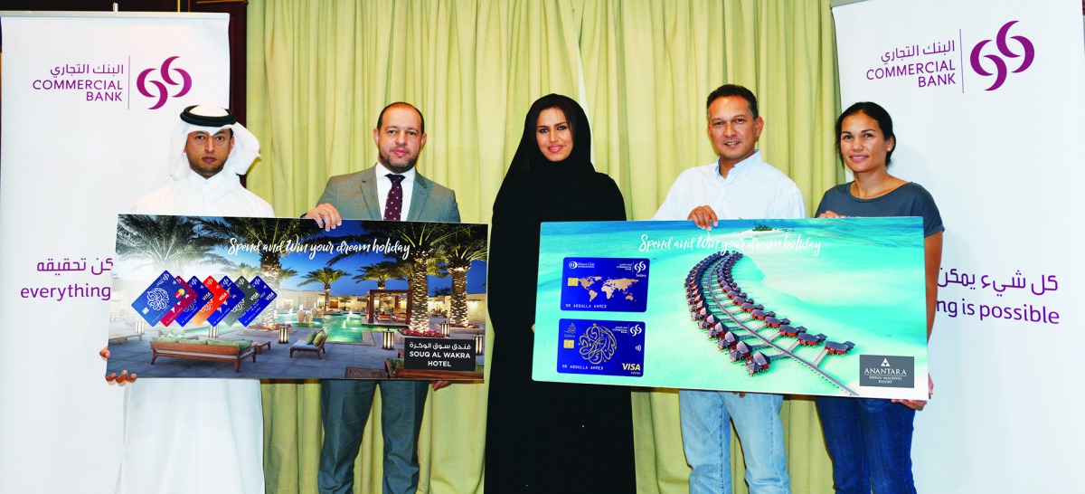 The winners of  “Spend & Win your Dream Holiday” campaign posing with officials of Commercial Bank.
