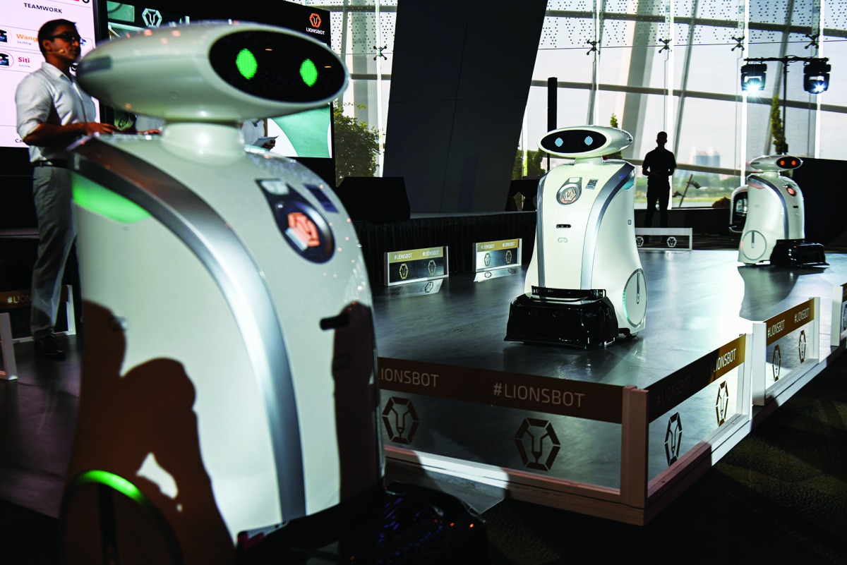 Autonomous cleaning robots moving on a platform during a launch in Singapore on July 17, 2019.  AFP / Roslan Rahman