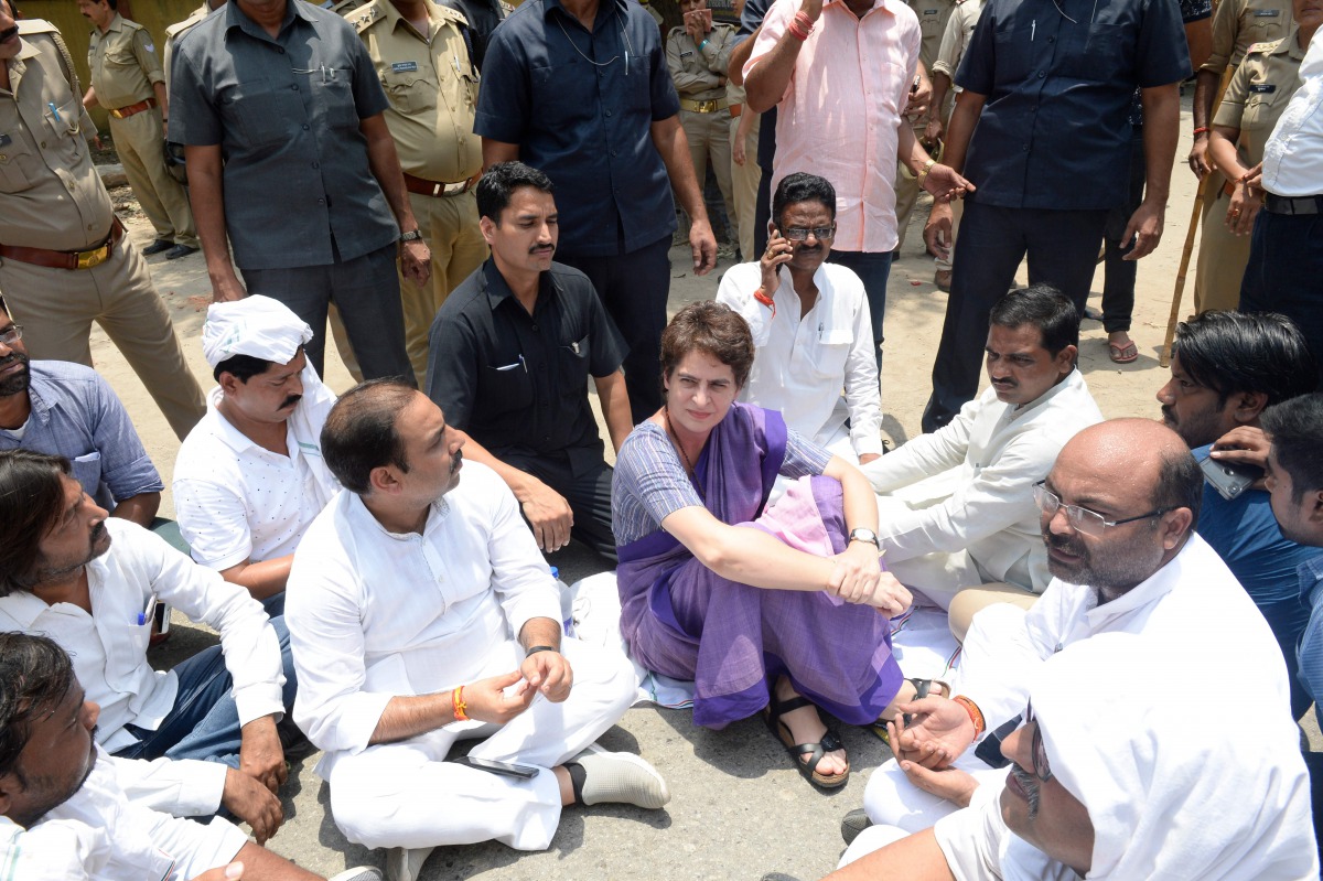 In this handout photo taken and released by the All India Congress Committee (AICC) Communication Department on July 19, 2019, Indian politician Priyanka Gandhi Vadra (C) participates ia a sitting in protest at Narayanpur District, Mirzapur, after being s