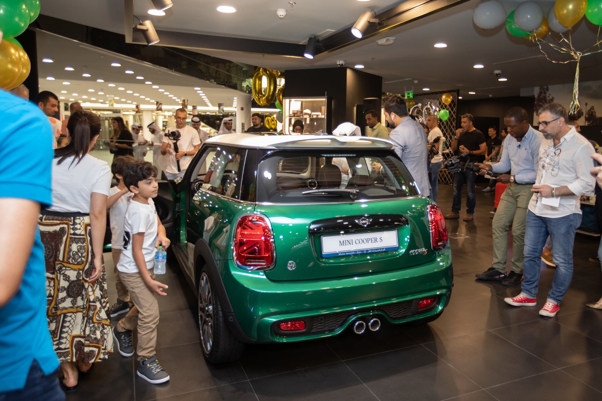 Alfardan Automobiles officials, mediapersons, and MINI car enthusiasts at the unveiling ceremony of the ‘MINI  60 Years Limited Edition’ car models in Doha. 
