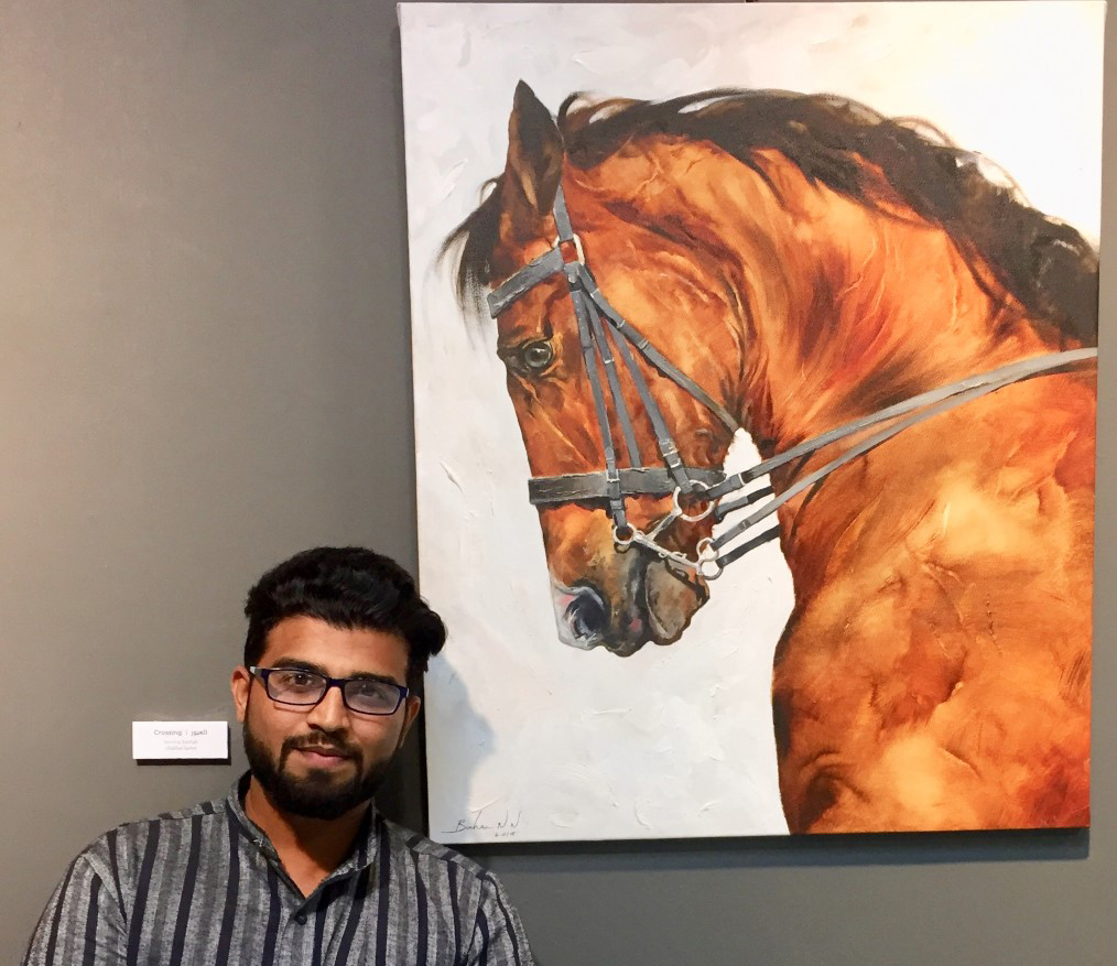 Indian artist Burhanuddin Nagarwala poses with one of his paintings on show at “Vibrant Earth — Fauna Collection” exhibition yesterday at Katara. (Pic: Raynald C Rivera/The Peninsula)