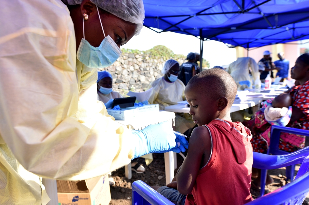 FILE PHOTO: A Congolese health worker administers ebola vaccine to a child at the Himbi Health Centre in Goma, Democratic Republic of Congo, July 17, 2019. REUTERS/Olivia Acland