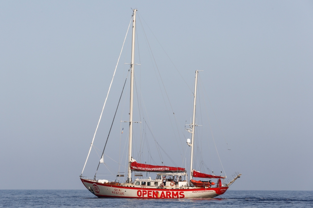 This file photo taken on July 17, 2018 shows the Spanish NGO Proactiva Open Arms' Astral sailing boat during a rescue mission in the Mediterranean open about 85 miles off the Libyan coast. (AFP / PAU BARRENA)