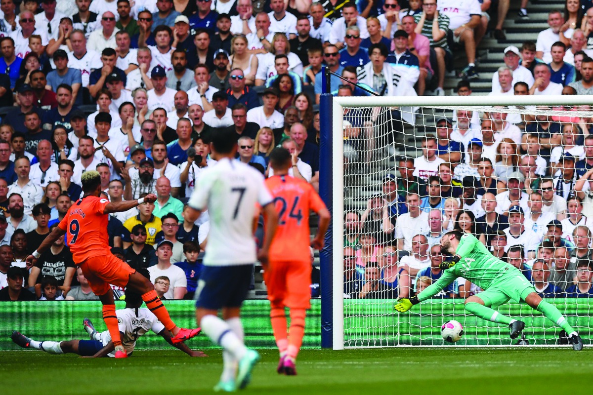 Newcastle United's Brazilian striker Joelinton (L) shoots past Tottenham Hotspur's French goalkeeper Hugo Lloris (R) to score the opening goal of the English Premier League football match between Tottenham Hotspur and Newcastle United at Tottenham Hotspur