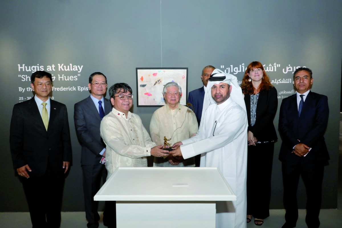 Filipino visual artist Frederick Epistola presents an art piece to Katara General Manager, Dr. Khalid bin Ibrahim Al Sulaiti, as Philippine Ambassador Alan L Timbayan (fourth left) and other ambassadors look on during the opening of the “Hugis at Kulay” e