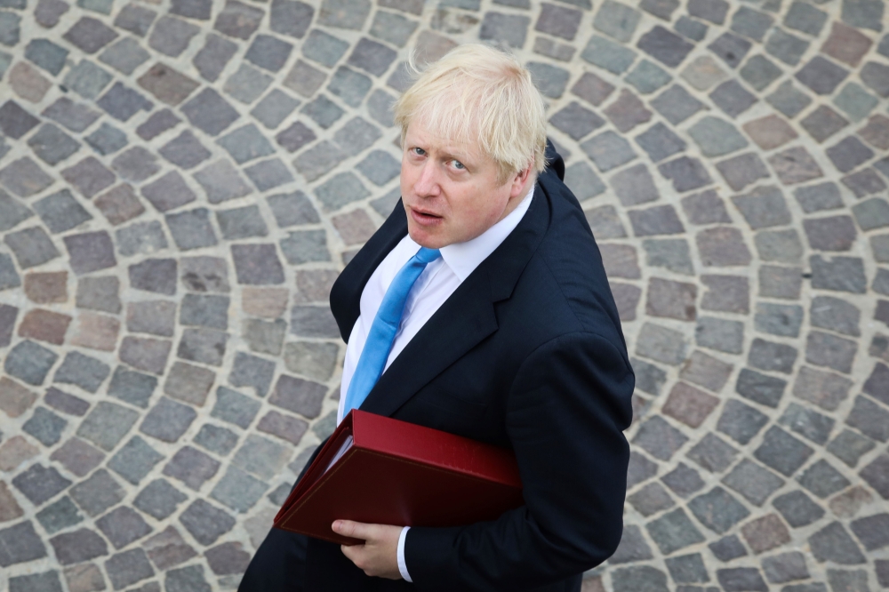 (FILES) In this file photo taken on August 26, 2019 British Prime Minister Boris Johnson walks towards his meeting in Biarritz, south-west France, on the third day of the annual G7 Summit. AFP / LUDOVIC MARIN