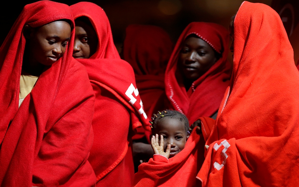 A migrant child intercepted off the coast in the Mediterranean Sea waves as she waits to disembark from a rescue boat at the port of Malaga, southern Spain, August 29, 2019. REUTERS/Jon Nazca