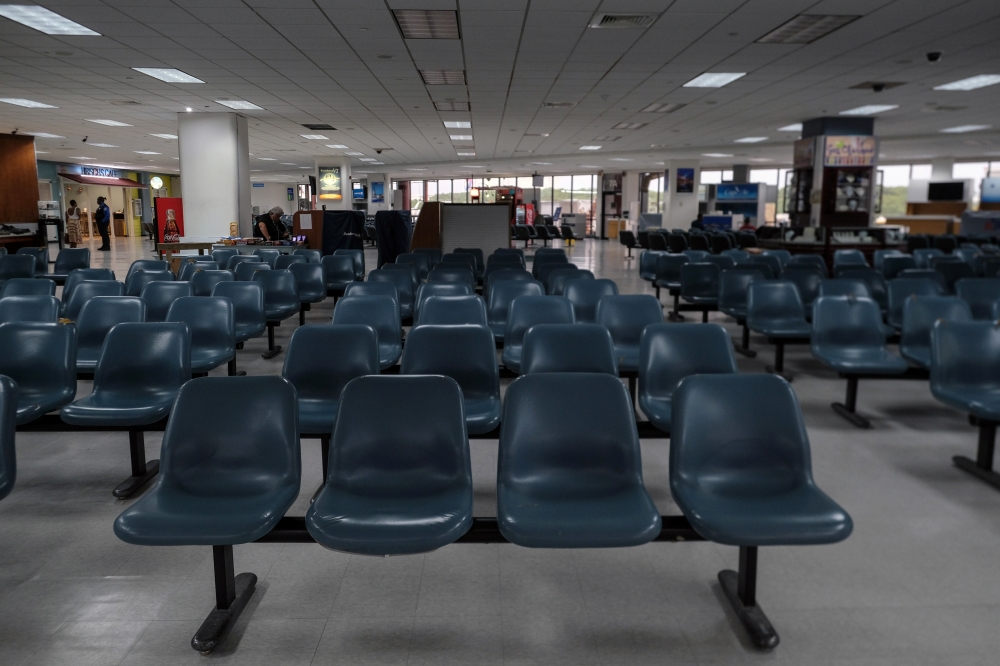 Empty counters and seats are seen at the gates of Charlotte Amalie Harbor Seaplane Base as most flights have been cancelled as Tropical Storm Dorian approaches in St Thomas, U.S. Virgin Islands August 28, 2019. Reuters/Gabriella N Baez
 