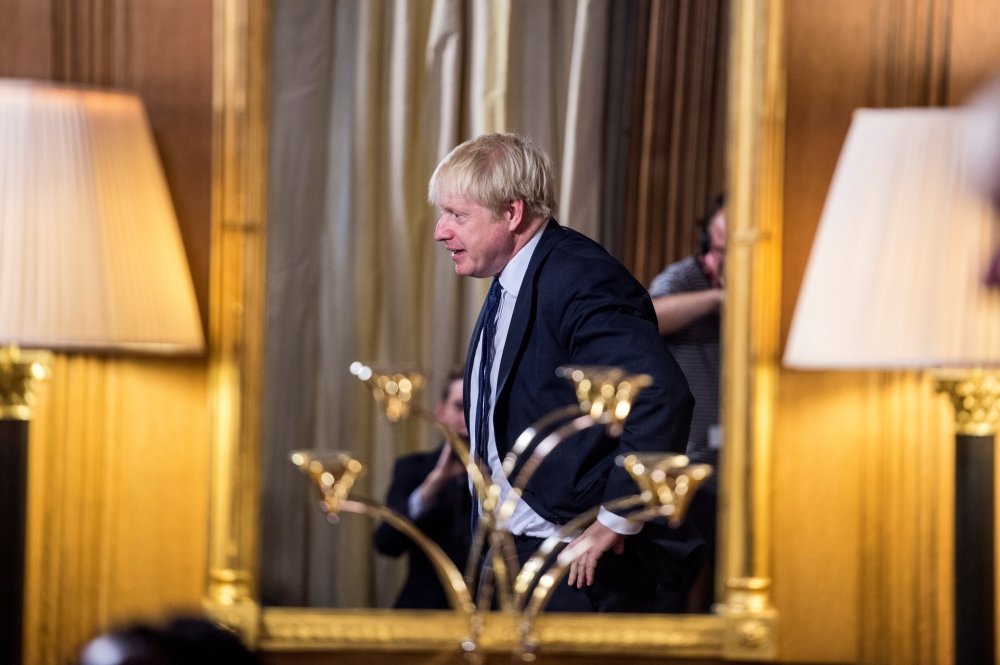 British Prime Minister Boris Johnson is reflected in a mirror as he answers questions from children aged 9-14 during an education announcement inside Downing Street in London, Britain, August 30, 2019. Jeremy Selwyn/Pool via REUTERS