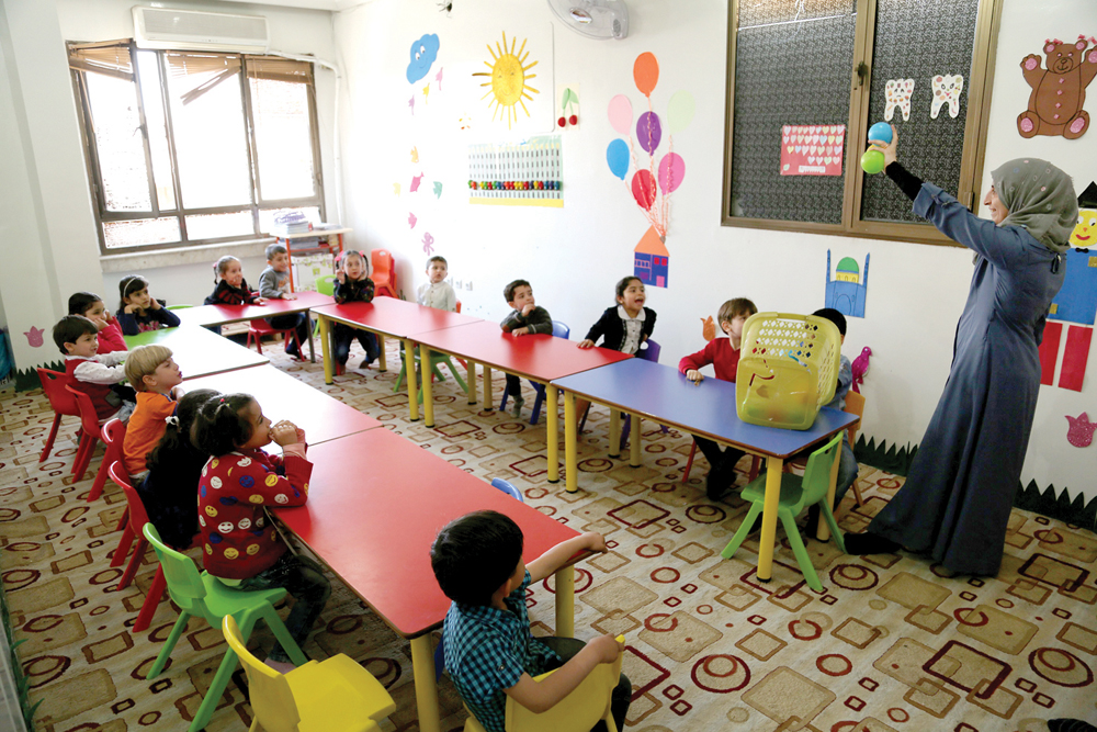 The Syrian children interacting with a teacher at a kindergarten, which was built under the education project of QRCS for Syrian refugees, in Turkey. 