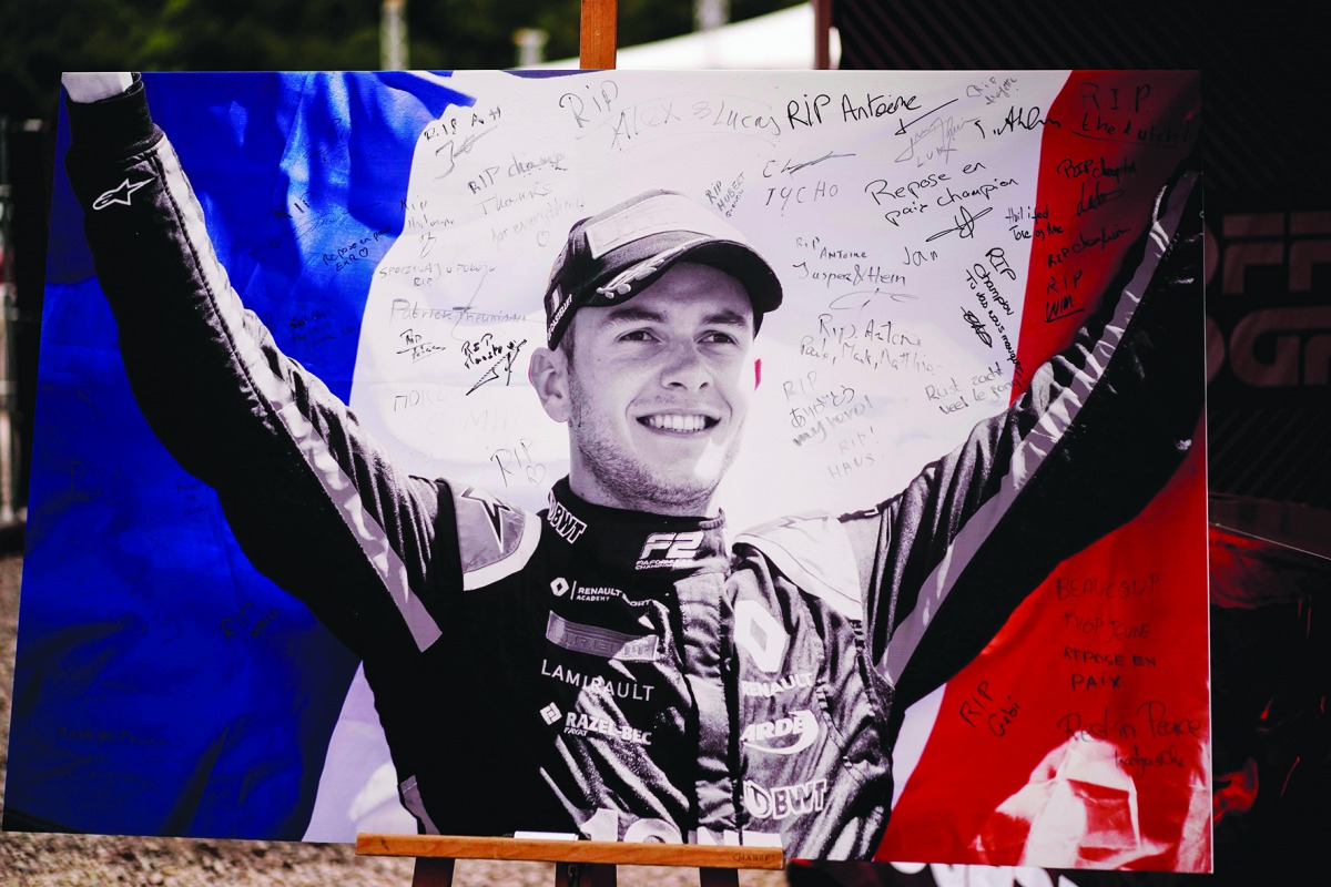 This picture taken on September 1, 2019 shows the portrait of BWT Arden's French driver Anthoine Hubert covered with condolence messages at the entrance of the Spa-Francorchamps circuit in Spa, Belgium. AFP / Kenzo Tribouillard
