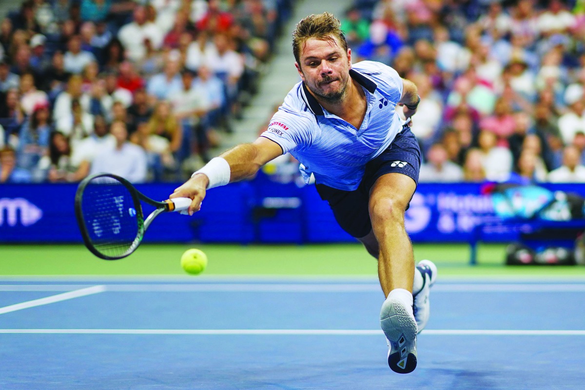 Stan Wawrinka of Switzerland reaches for the ball from Novak Djokovic of Serbia in their Round Four Men's Singles tennis match during the 2019 US Open at the USTA Billie Jean King National Tennis Center in New York on September 1, 2019. AFP / Dominick Reu