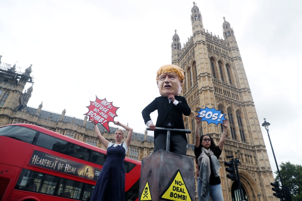 Protestors, with one of them dressed as Britain's Prime Minister Boris Johnson, demonstrate outside the Houses of the Parliament in London, Britain September 3, 2019. REUTERS/Simon Dawson
