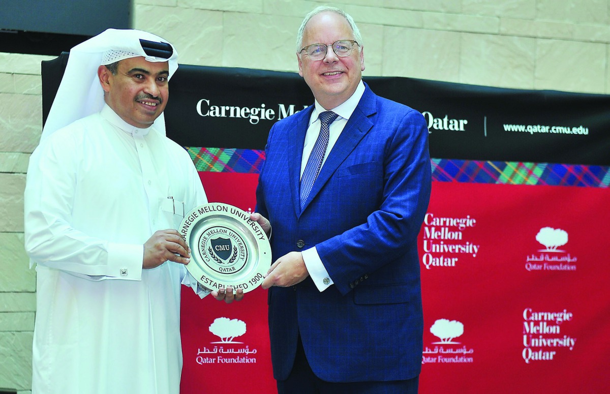 H E Ali bin Ahmed Al Kuwari, Minister of Commerce and Industry, receiving a memento from Michael Trick, Dean of Carnegie Mellon University in Qatar, after delivering the Dean’s Lecture Series, yesterday. Pic: Baher Amin/The Peninsula