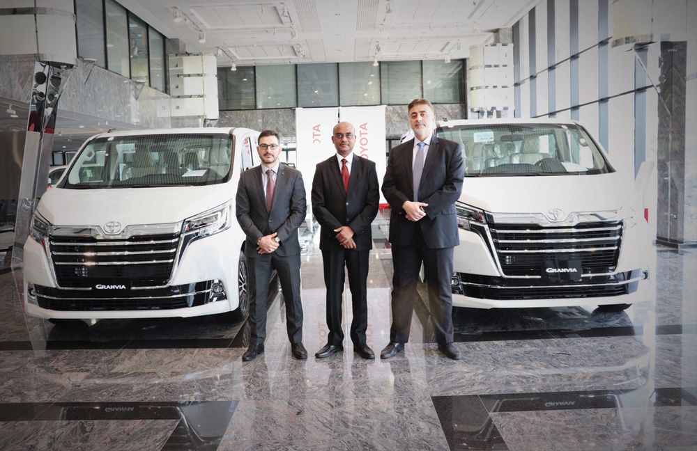 Officials pose with the newly-unveiled Toyota Granvia luxury van.