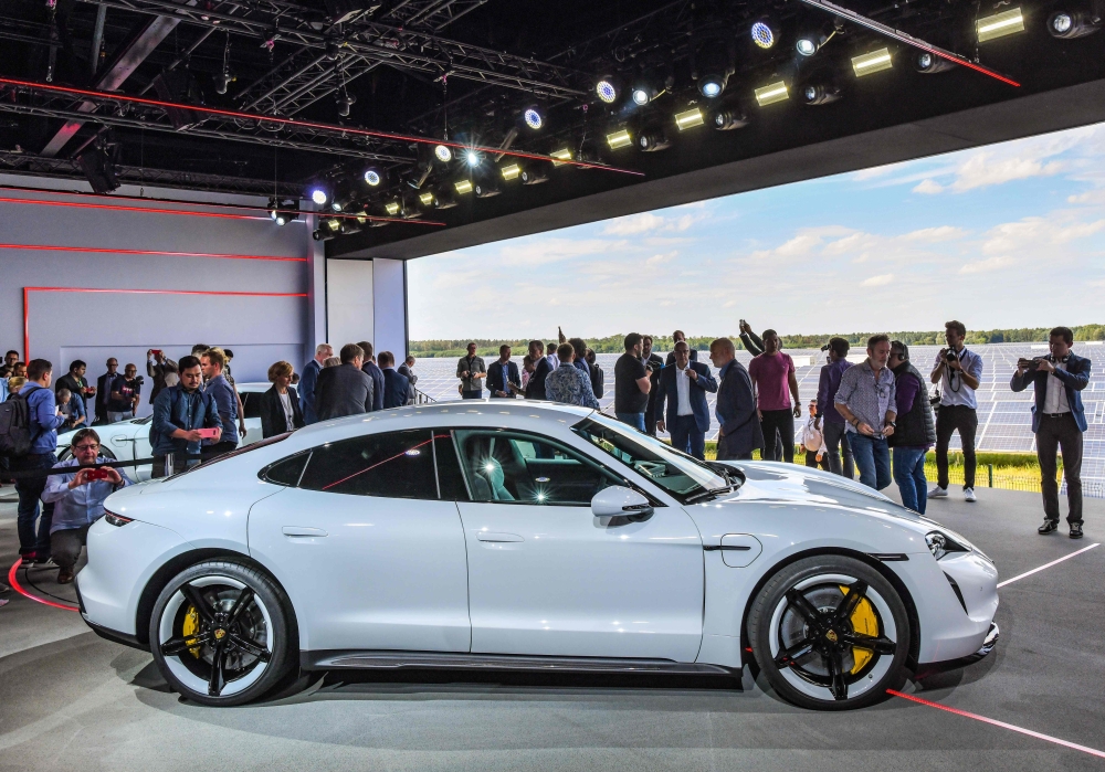 The Porsche Taycan electric car is presented to the public as a world premiere on September 4, 2019 in a hall of the airfield of Neuhardenberg, eastern Germany.  AFP / DPA / Patrick Pleul 