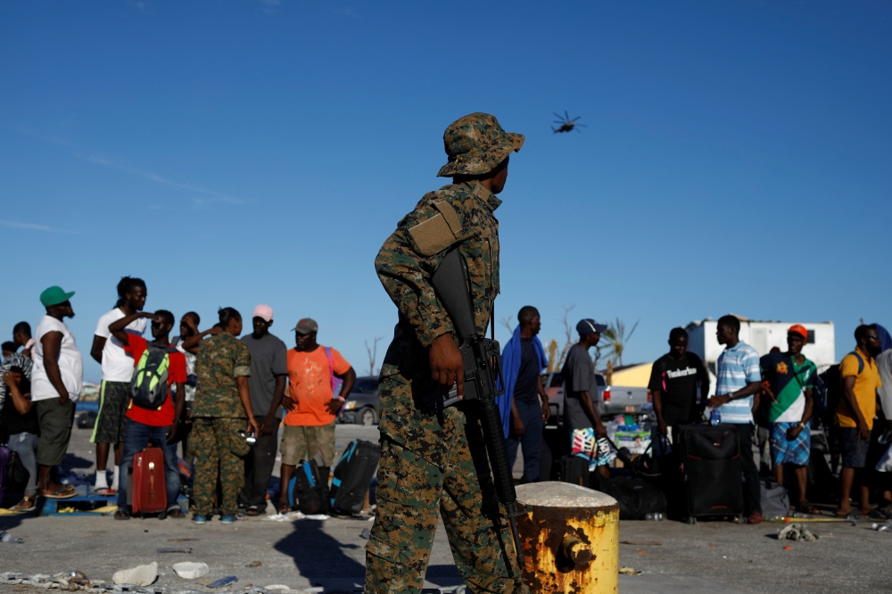 A soldier stands guard at Marsh Harbour Government Port during an evacuation operation after Hurricane Dorian hit the Abaco Islands in Marsh Harbour, Bahamas, September 6, 2019. REUTERS/Marco Bello