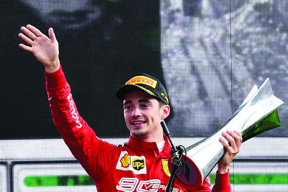 Winner Ferrari's Monegasque driver Charles Leclerc celebrates with his trophy on the podium after the Italian Formula One Grand Prix at the Autodromo Nazionale circuit in Monza on September 8, 2019. AFP / Miguel Medina
