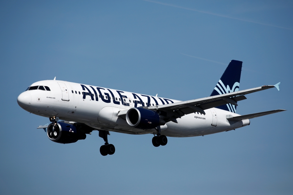 An Airbus A320-214 aircraft, operated by Aigle Azur, lands at Orly Airport near Paris, France, September 6, 2019. REUTERS/Benoit Tessier