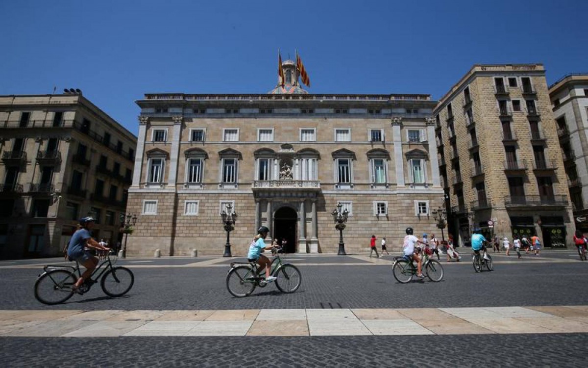 People cycle across Sant Jaume square in Barcelona, Spain, August 4, 2017. Reuters/Albert Gea